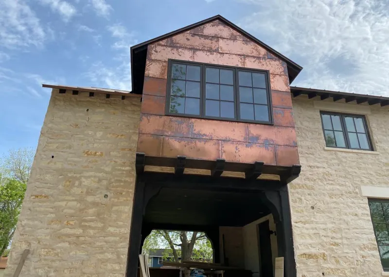 Copper metal panel facade on a stone building for Skylight Installation in Anchorage