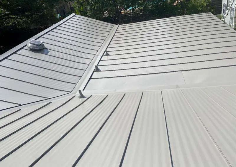 Solar attic fan installed on a metal roof for Roof Ventilation in Anchorage